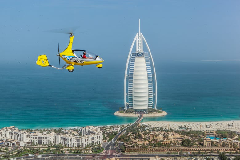 Autogiro in volo vicino al Burj Al Arab
